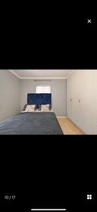 a bedroom with a bed with a blue blanket at YA Eagle Wings Self Catering Shared Single room Apt B in Cape Town
