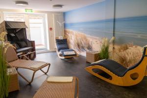 a living room with a beach mural on the wall at DLRG Tagungszentrum Hotel Delphin in Bad Nenndorf