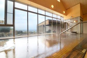an empty room with large windows and an empty floor at Hotel Grand Mer Sankaiso in Ajigasawa