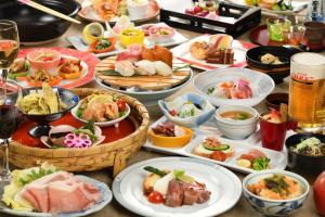 a table with many plates of food on it at Hotel Grand Mer Sankaiso in Ajigasawa