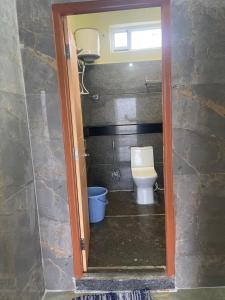 a small bathroom with a toilet and a window at Amaravathi Residency in Nārāyanavanam
