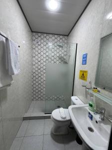 a bathroom with a shower and a toilet and a sink at Best Guest House in Andizhan +28 photos