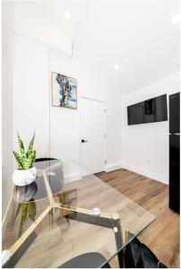 a living room with a glass table and a plant at Stellar Sherman Oaks One Bedroom close to Universal Studios in Burbank