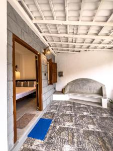 a room with a bed and a blue rug at Tidal Nest in Weligama