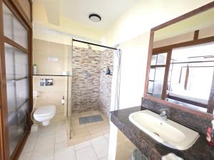 a bathroom with a sink and a toilet at Chic two bedroom Beachfront apartment 5th floor in Ukunda +10 photos