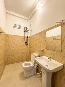 a bathroom with a toilet and a sink at Tidal Nest in Weligama