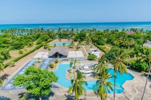 an aerial view of the resort with the ocean in the background at Chic two bedroom Beachfront apartment 5th floor in Ukunda