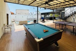 a pool table in the middle of a room at 1715 House - White Rhino in Rawai Beach