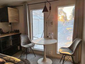 a room with a table and two chairs and a window at Guest house - Northern tealight in Rovaniemi