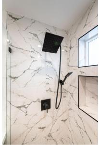 a bathroom with a shower with a laptop on the wall at Stellar Sherman Oaks One Bedroom close to Universal Studios in Burbank +11 photos