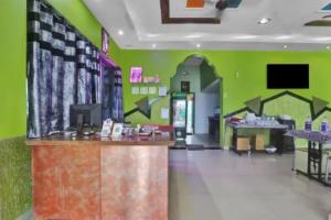 a store with a green wall with arrows on it at Hotel kashish in Waigaon