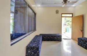 a room with two blue seats and a window at Hotel kashish in Waigaon