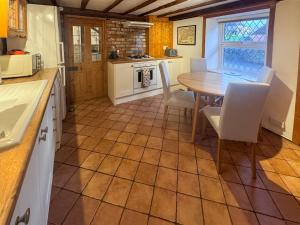 a kitchen and dining room with a table and chairs at Arcadia Cottage, Mere in Mere