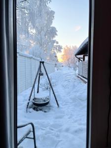 a swing in a yard covered in snow at Guest house - Northern tealight in Rovaniemi