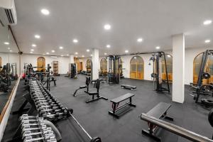 a gym with a lot of treadmills and machines at Diamonds Mapenzi Beach in Kiwengwa