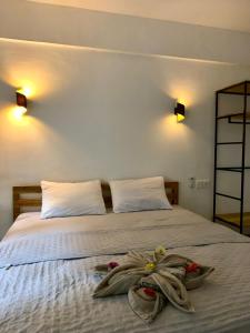 a bedroom with a bed with towels on it at Bale Hotel & Cowork in Kuta Lombok