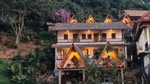 a house on a hill with lights on it at Pont NongKhiaw in Nongkhiaw