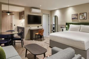 a hotel room with a bed and a living room at Residence Inn by Marriott Edinburgh in Edinburgh