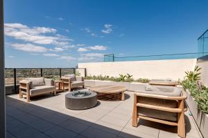 a patio with chairs and tables on top of a building at Winx Trackside Moonee Ponds in Moonee Ponds +14 photos