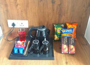 a tray with a coffee maker and snacks on a table at The Walnut House in Pahalgām