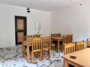 a dining room with wooden tables and chairs at The Walnut House in Pahalgām +20 photos