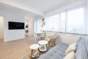 a living room with a couch and a table at Rezidence Sadová Zlín in Zlín +127 photos