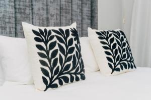 two black and white pillows on a bed at Elle Residence in Gaborone +47 photos