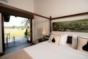 a bedroom with a bed and a large window at Kirindi Paddy Isle - Boutique Villa in Negombo +98 photos