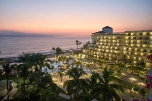 a view of a hotel and the ocean at sunset at Marriott Puerto Vallarta Resort & Spa in Puerto Vallarta