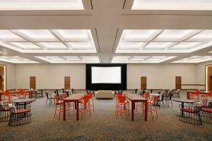 a large room with tables and chairs and a screen at Marriott Puerto Vallarta Resort & Spa in Puerto Vallarta +232 photos
