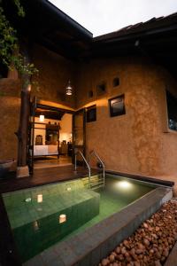 a pool of water in the middle of a house at Kirindi Paddy Isle - Boutique Villa in Negombo