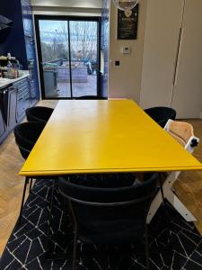 a yellow table in a room with chairs at Apartment with terrace Mérignac in Mérignac +4 photos