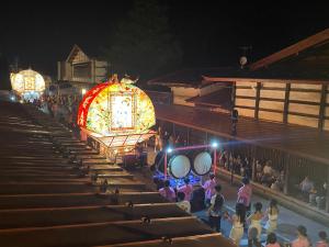 a crowd of people watching a parade at night at Tabinoyado Saikawa in Kuroishi +46 photos