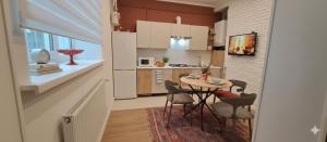 a kitchen with a table and chairs in a room at Flat in cottage close to the centre parking, WiFi, BBQ in Lviv +25 photos