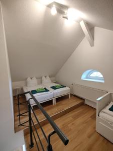 a room with two beds in a attic at Haffquartier - "Zur Alten Bäckerei" in Mönkebude +59 photos