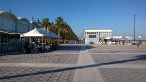 a street with tables and chairs and umbrellas at Alex Apartment in Valencia