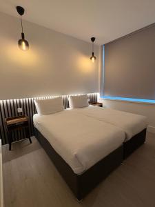 a bedroom with a large bed with two pillows at RIOSHOUSE Henley in Henley on Thames +23 photos