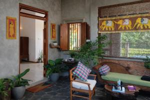 a living room with a couch and some plants at Cinnamon Villas in Ambalangoda