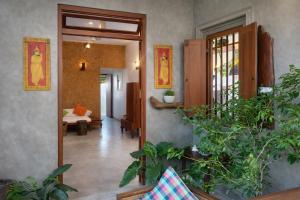 a hallway with a door open to a living room at Cinnamon Villas in Ambalangoda