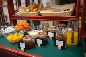 a table topped with bowls of fruit and jars of honey at Quick Palace Saint Brieuc in Tregueux