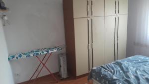 a bedroom with a bed and a dresser next to a closet at Dolores in Tešanj