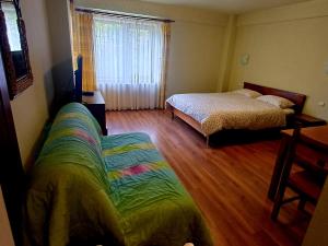 a bedroom with two beds and a couch in it at Belvedere GreșuLepșa in Greşu