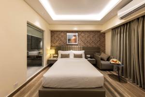 a hotel room with a bed and a couch at SureStay by Best Western in Cox's Bazar