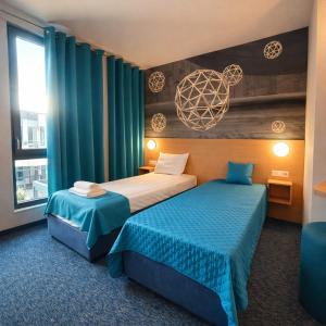 a hotel room with two beds and a window at WESTGATE Hotel - FREE PARKING in Veliko Tŭrnovo