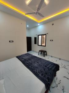 a bedroom with a large bed and a ceiling at Hotel Ekana in Chhatarpur +16 photos