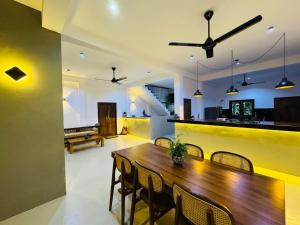 a dining room with a wooden table and chairs at Luma Malee Resort in Dickwella