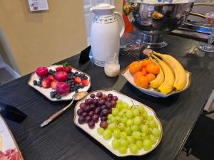 three plates of fruit on a table with a blender at Solvang in Assens +14 photos