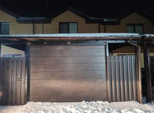 a garage door with snow on top of it at Дім весняний in Sheremetka +4 photos