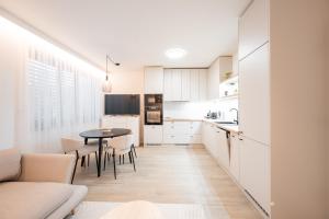 a kitchen and dining room with a table and chairs at Rezidence Sadová Zlín in Zlín