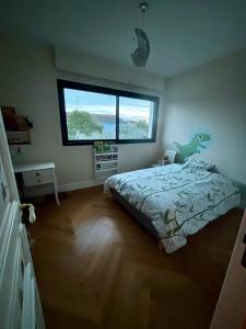 a bedroom with a dinosaur bed and a large window at Apartment with terrace Mérignac in Mérignac